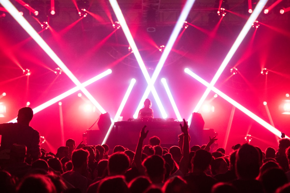 Crowd dancing under laser lights at Favela nightclub